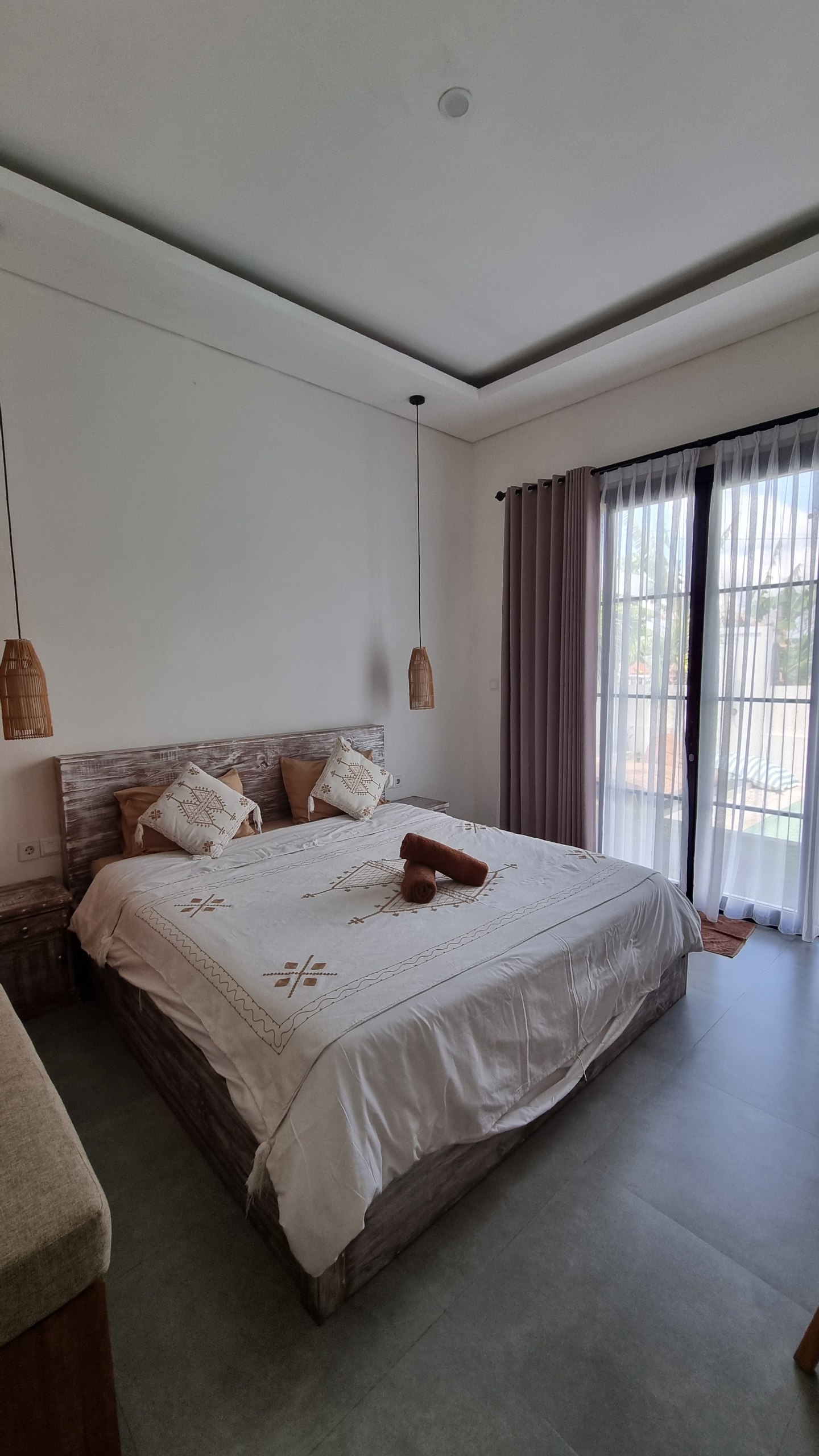 Bedroom with glass doors opening toward the pool